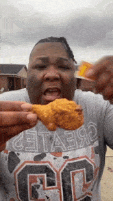 a man wearing a shirt with the number 30 on it is holding a piece of fried chicken in his hand