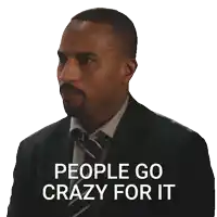 a man in a suit and tie has a sticker on his face that says " people go crazy for it "