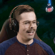 a man wearing glasses and headphones with a mustache