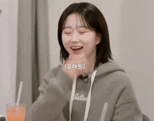 a girl wearing a gray hoodie with the word satur on it