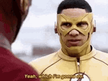 a man in a flash costume is talking to another man .