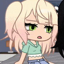 a girl with blonde hair and green eyes is wearing a crop top and jeans