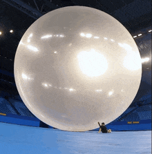 a large balloon in a stadium with a sign that says rio arena on it