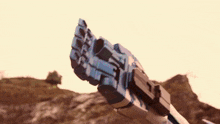 a close up of a robot 's arm holding a gun