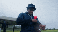 a man wearing a nike hat is standing in front of a golf cart