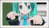 a cartoon girl with green hair and blue eyes is pointing at something .