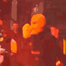 a blurred image of a crowd of people with one wearing a yellow shirt that says ' oakland '