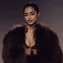 a woman wearing a fur coat and braided hair