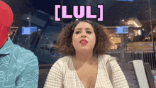 a woman with curly hair has the word lul written on her face