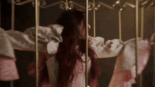 a woman with red hair is in a cage