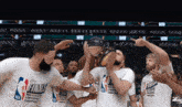 a group of basketball players wearing white shirts that say nba eastern conference champions