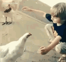 A Boy And His Chicken GIF - Chicken Hug Boy GIFs