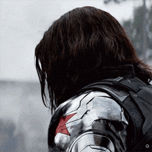 a close up of a person 's back with a red star on his chest