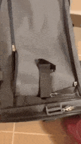 a close up of a suitcase with a strap and a zipper