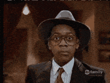a man wearing glasses and a hat with abc family on the bottom right