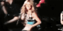 a blurry image of a woman dancing on a stage .