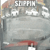 a white van is parked on the side of the road in front of a building that says $ zippin