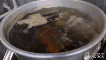 a pot of boiling water with the words made in animatica on the bottom of it