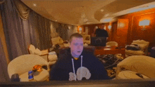 a man is sitting in a chair in front of a computer monitor
