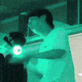 a man in a white shirt is standing in a room with a green light behind him