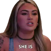 a woman wearing a choker necklace and earrings is saying she is