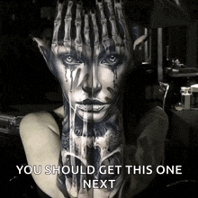 a woman has a tattoo of a woman 's face on her arm