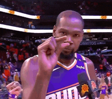 a basketball player wearing a purple jersey that says paypal