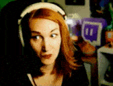 a woman wearing headphones looks at the camera with a purple box in the background that says 11