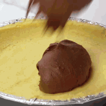 a pie crust is being covered in chocolate sauce