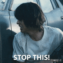 a netflix ad shows a man holding a gun and the words stop this