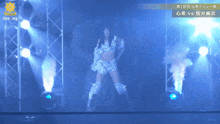 a woman stands on a stage in front of a sign that says rpw mg