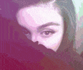 a pixelated image of a woman covering her face with a purple background