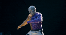 a statue of a man with a purple top