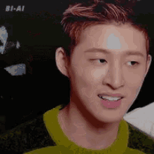 a young man with red hair is smiling and wearing a green shirt .