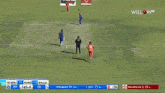 a cricket game is being played in front of a large dafabet banner