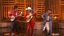 a group of musicians are performing on stage with nbc written on the bottom