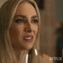 a woman drinking a glass of water with a netflix logo in the corner