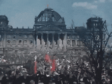 a crowd of people gathered in front of a building