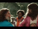 a man with a beard and a woman with curly hair are talking to each other