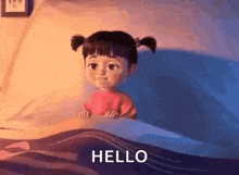 boo from monsters inc is sitting in a bed with the words `` hello '' written on it .