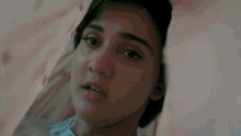 a close up of a woman 's face behind a blanket