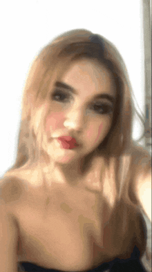 a blurry picture of a woman taking a picture of herself