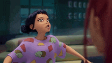 a girl in a purple shirt with turtles on it looks at another girl