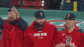 two men with beards are sitting next to each other in a stadium .