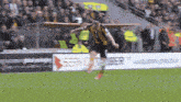 a soccer player is jumping in the air on the field