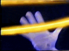 a hand in a white glove is holding a yellow pencil
