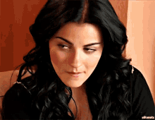 a close up of a woman 's face with the word editsmate below it