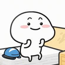 a cartoon character is sitting on a bed next to a blue bell and smiling .
