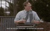 a man in a suit and tie is holding a briefcase with a stapler in it .