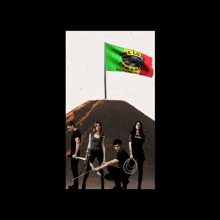 a group of people standing in front of a flag that says one love at the top